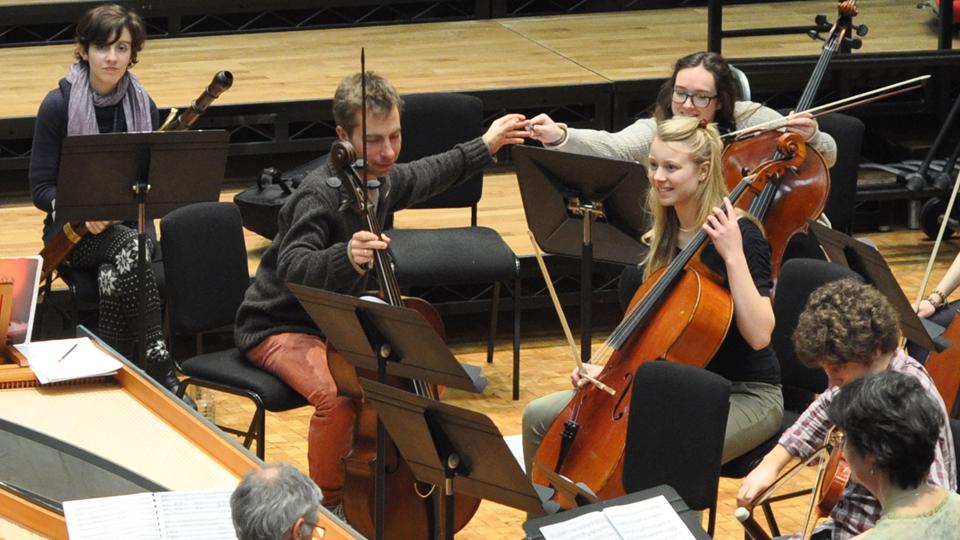 Orchestral musicians rehearse with Cellos